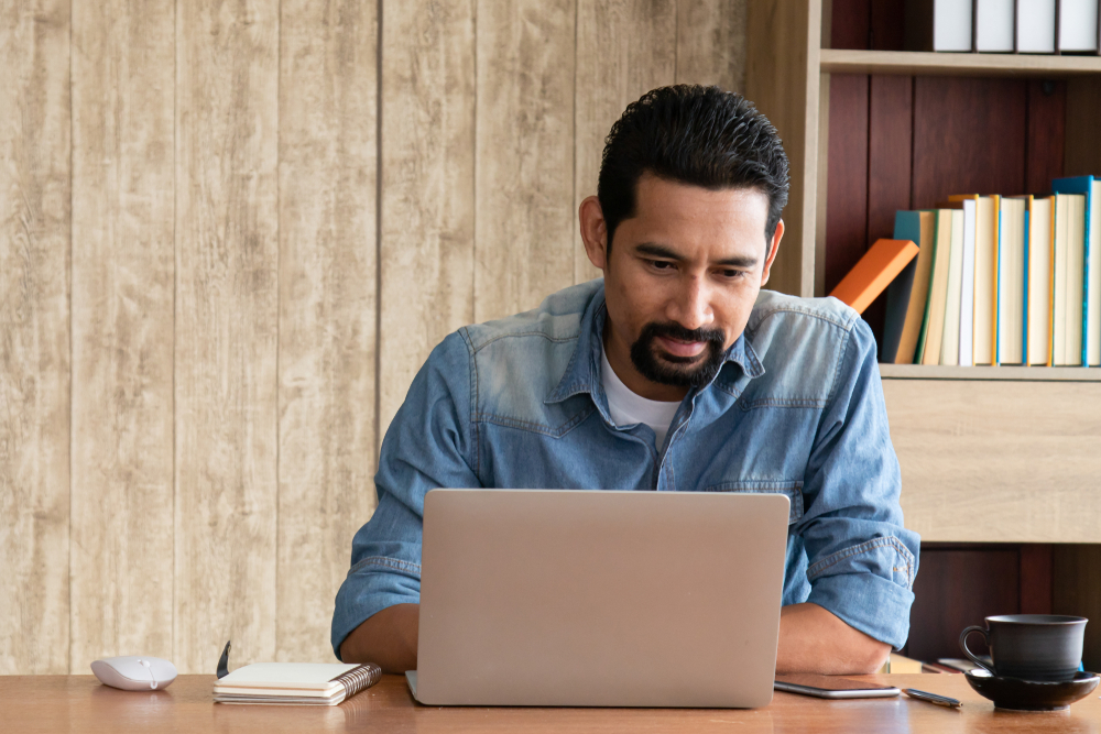 Image of man sitting in his office desk with his computer.