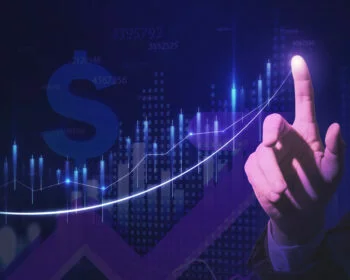 Hand pointing at a rising financial chart on a dark background.