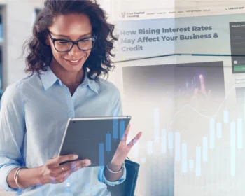 Woman with glasses holding a tablet, with financial charts and a blog page in the background.