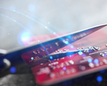 "Close-up of scissors cutting a credit card."