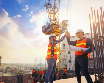 Architect,And,Engineer,Construction,Workers,Shaking,Hands,While talking about quick pay