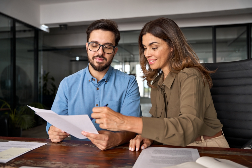 Two people deciding best factoring companies for their cashflow needs.
