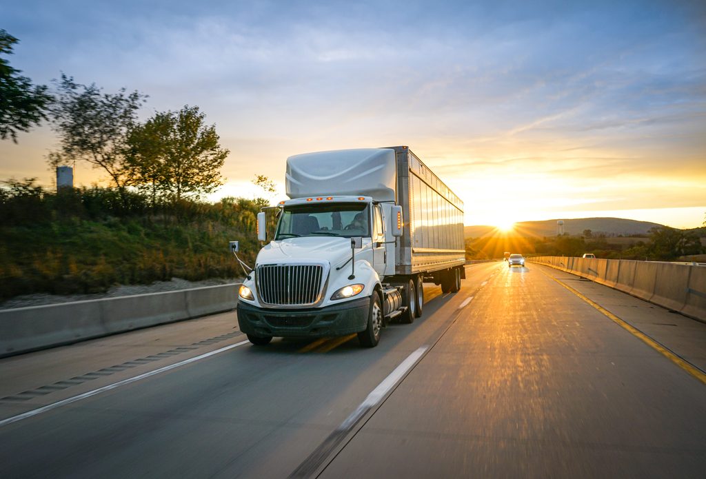 Common Trucking Factoring Mistakes and How to Avoid Them 1 Semi truck transporting freight on a highway at sunset