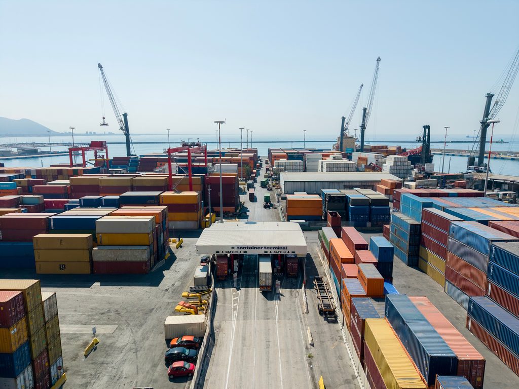 Invoice Factoring Challenges in the Transportation Industry 1 Shipping containers and cranes at a busy freight terminal and commercial port
