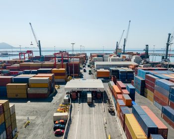 Shipping containers and cranes at a busy freight terminal and commercial port